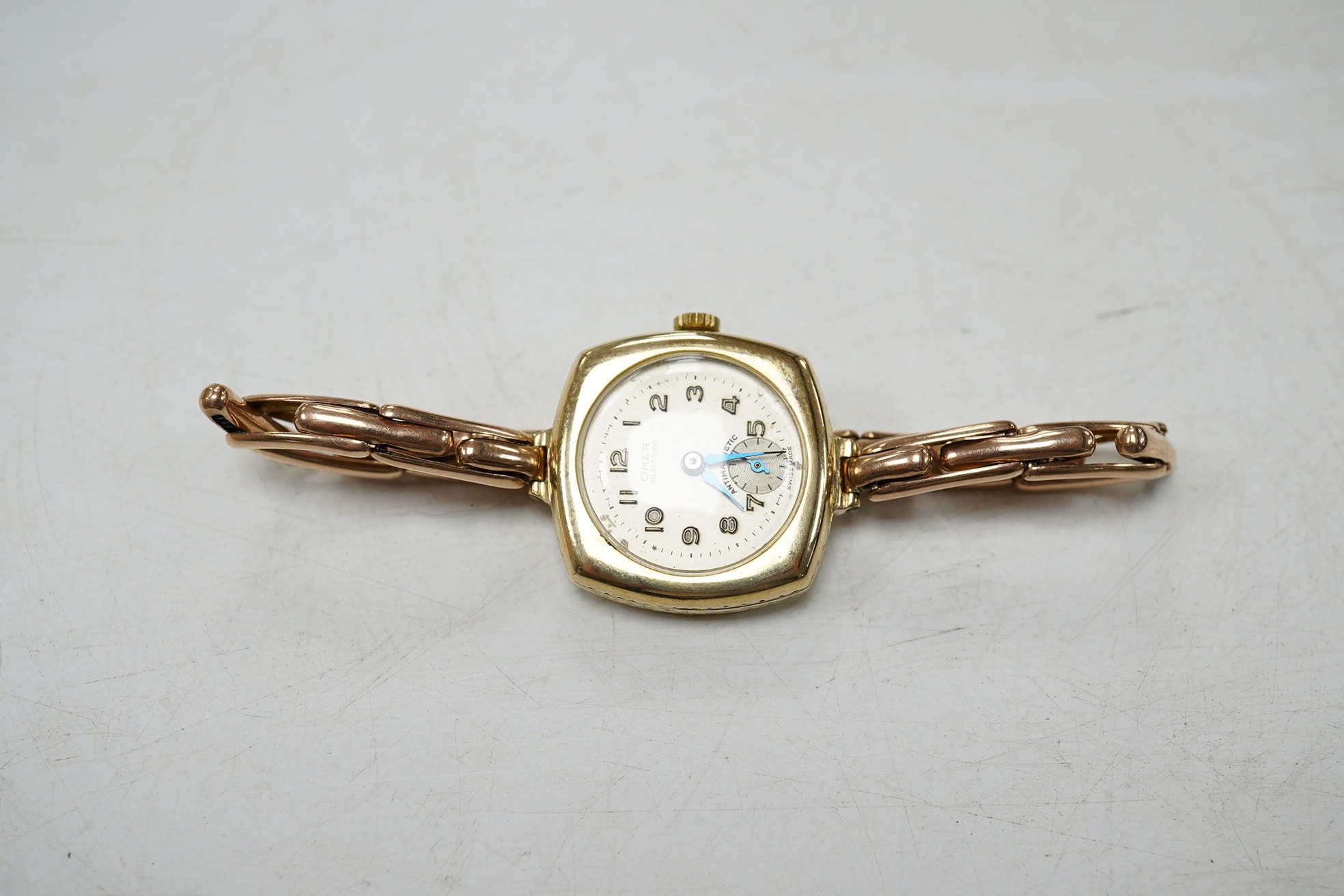 A lady's 9ct gold Omer manual wind wrist watch, on a 9ct expanding bracelet, gross weight 17.7 grams. Condition - poor to fair